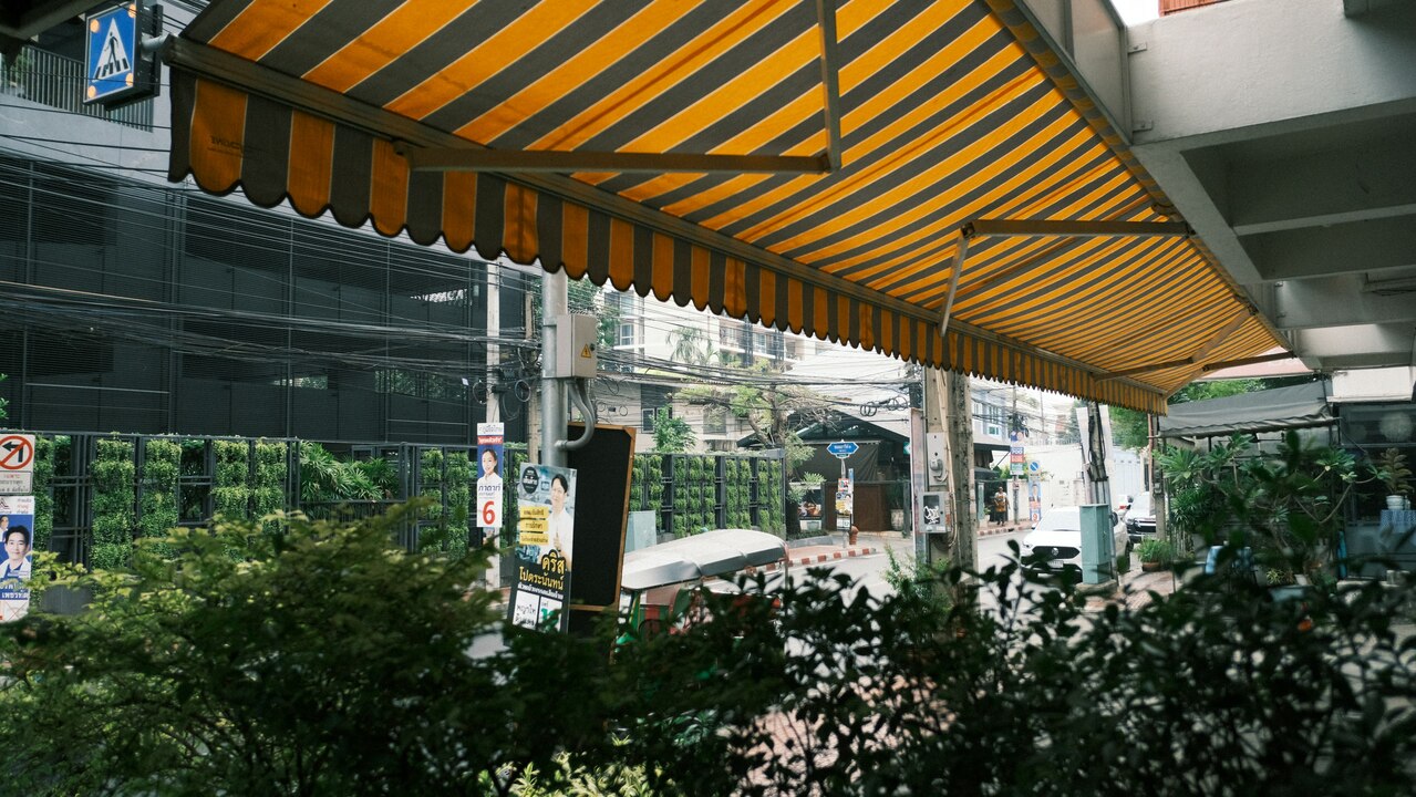 un toldo a rayas amarillas y negras sobre una calle