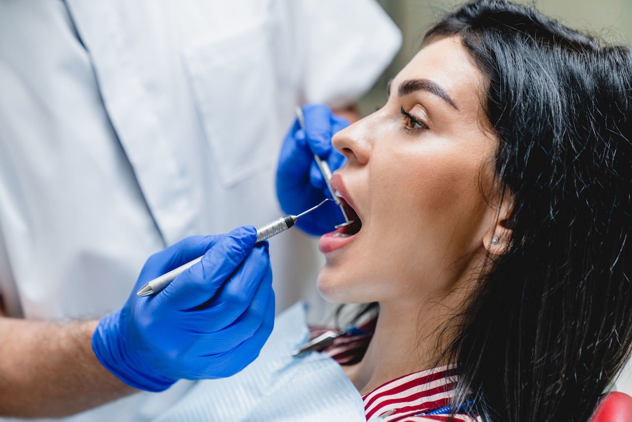 woman undergoing an evaluation for oral cancer