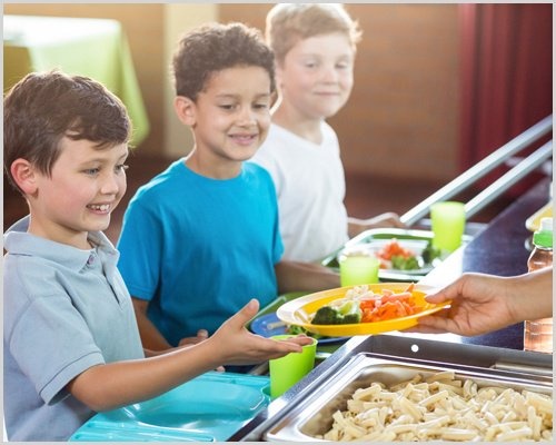 Woman Serving Food To Children