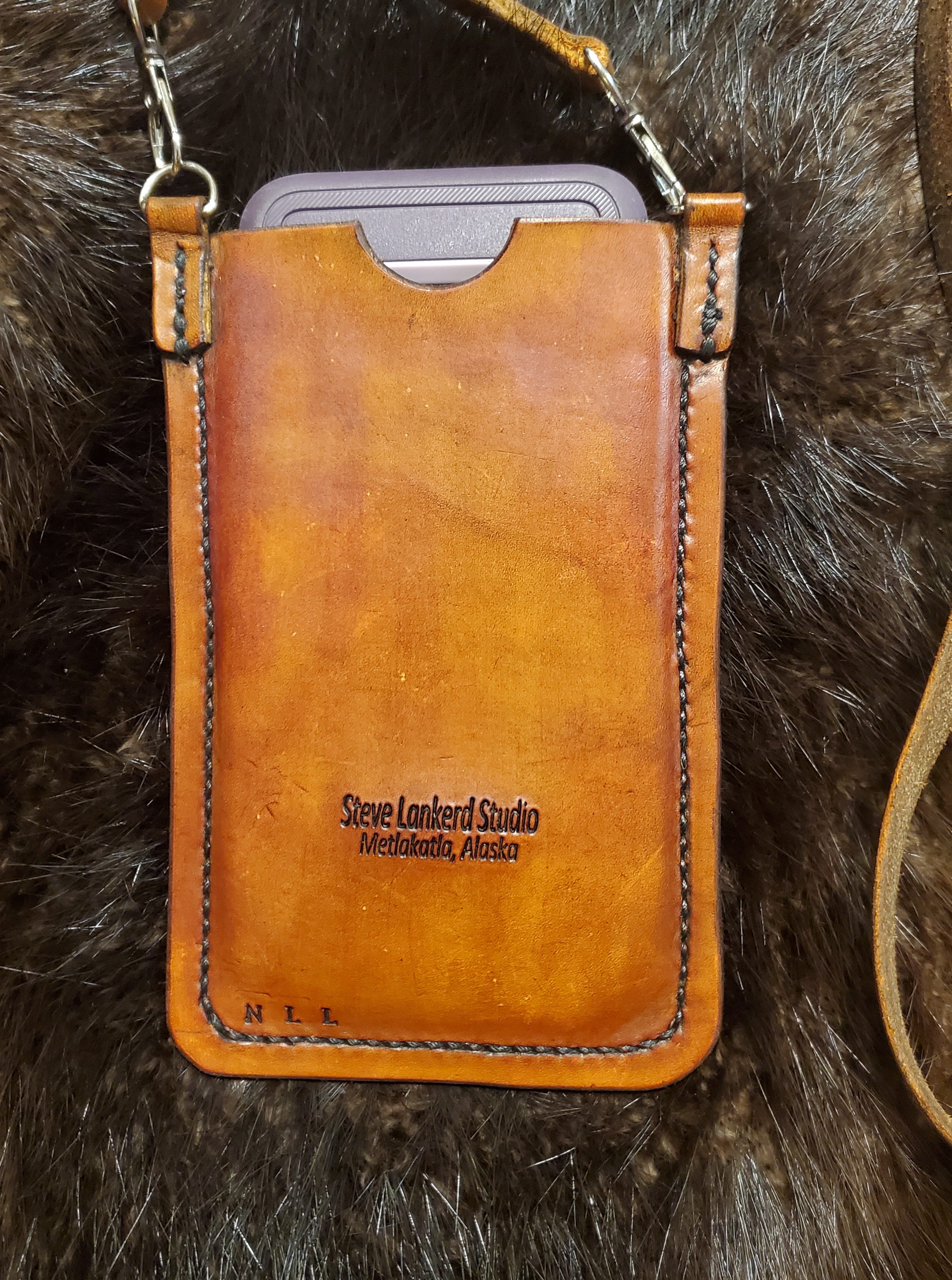 (Back)  Leather cell phone case with strap, hand tooled and hand stitched,  $85.00