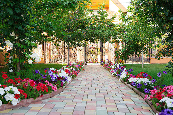 Colorful brick footpath with flowers Colorful brick footpath with flowers