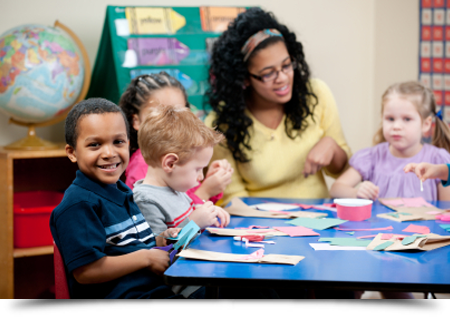 Children with teacher doing crafts||||