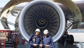 Airplane Mechanics in Front of Jumbo Jet Engine