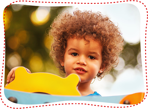 Afro American Boy on Playground in Kindergarten