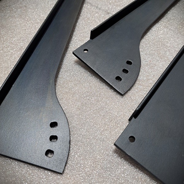 AM.13 smoky black patinated finish.
