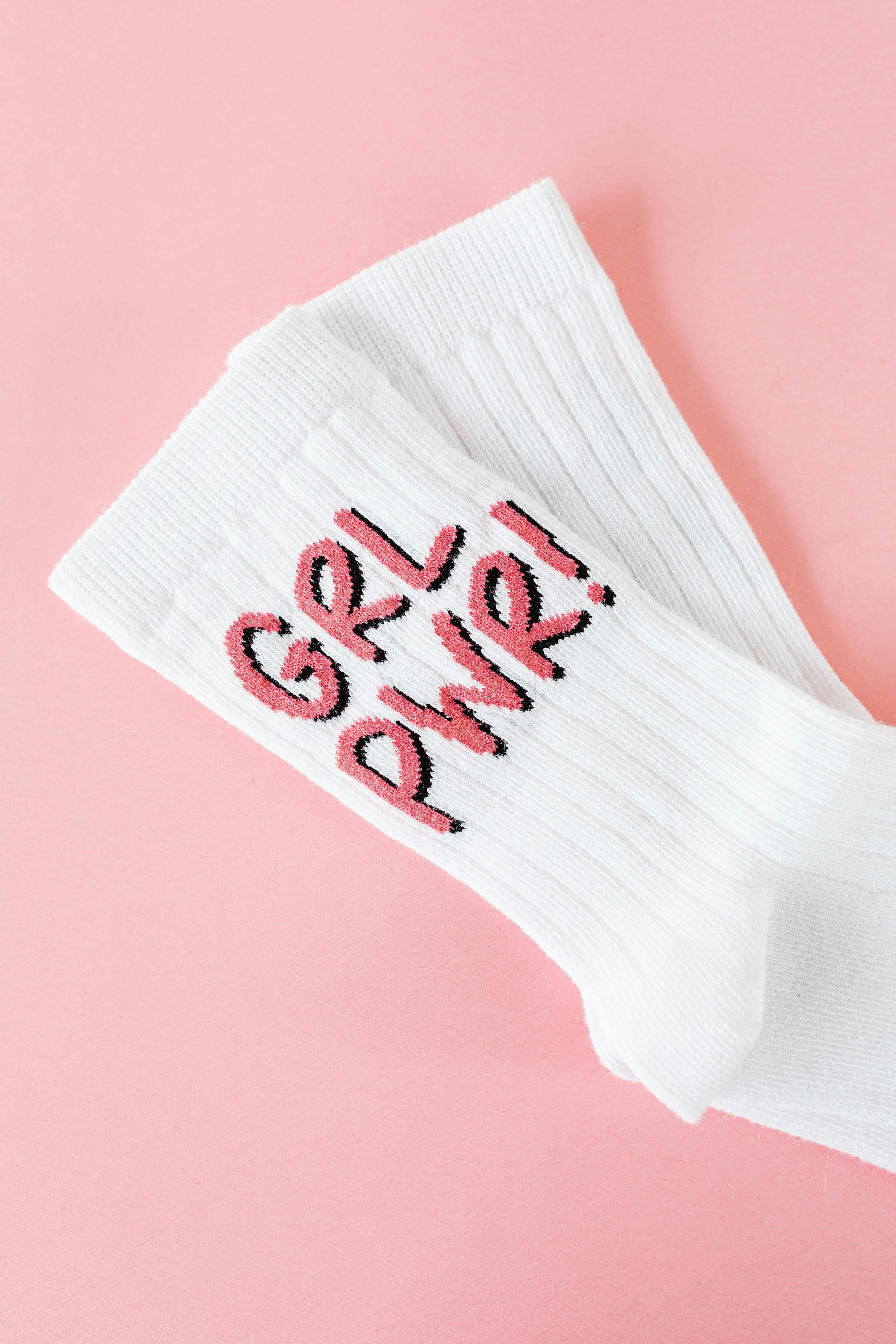 White socks with girl pwr embroidered on them