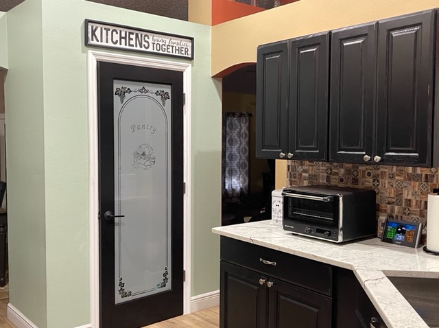 Stylish pantry with custom door for plenty of storage.