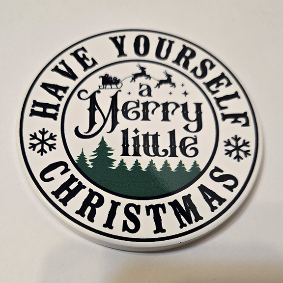 Round ceramic coaster with a have yourself a merry little Christmas design