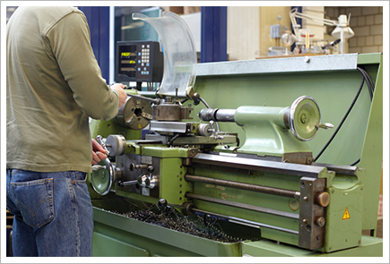 Man working on lathe||||