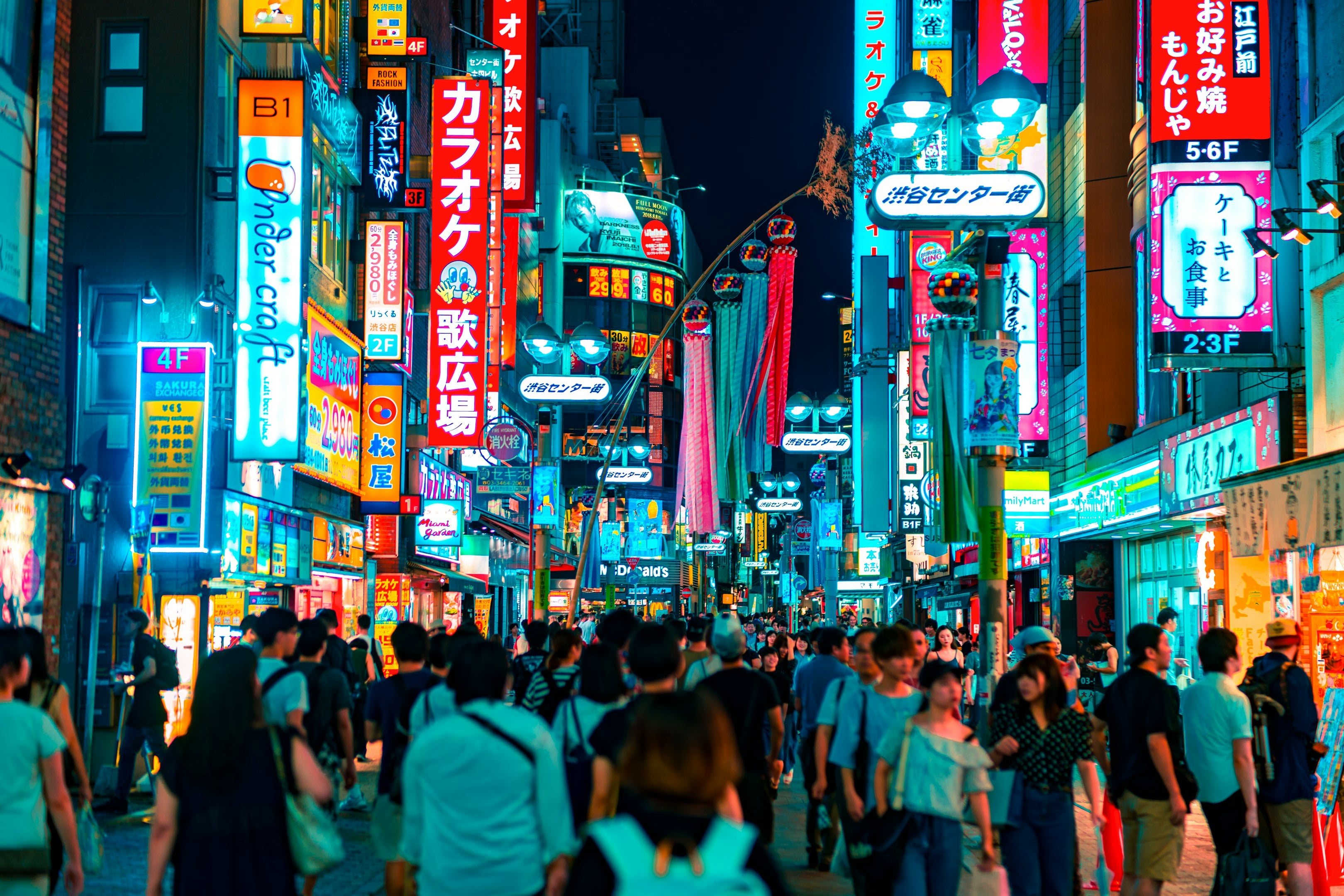 Crowded Tokyo street at night with vibrant neon signs and bustling pedestrians. Crowded Tokyo street at night with vibrant neon signs and bustling pedestrians.