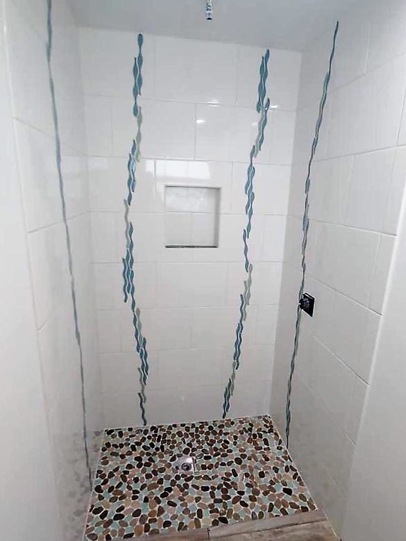 One-of-a-kind custom shower enclosure with unique tile work and design.