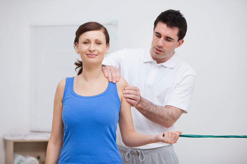 Woman being massaged by a physiotherapist Woman being massaged by a physiotherapist