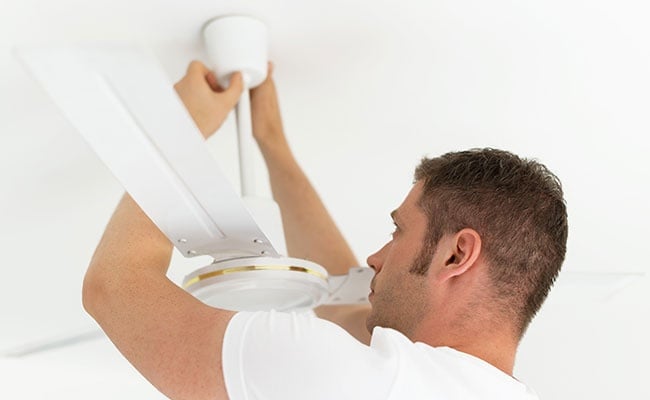 Male Technician Installing Ceiling Fan