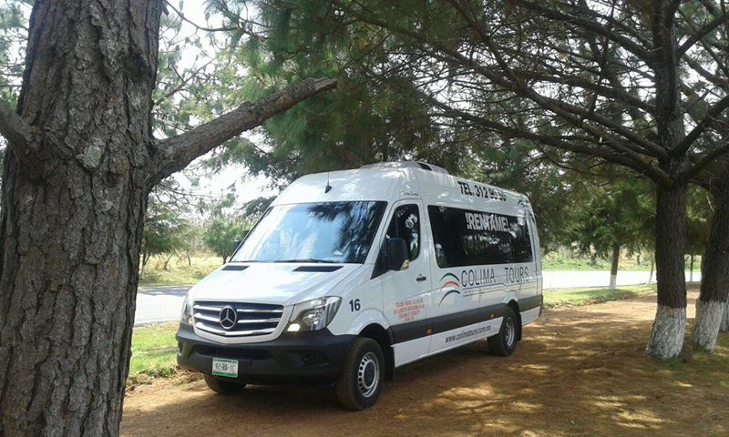 Red car in front of a sea landscape
