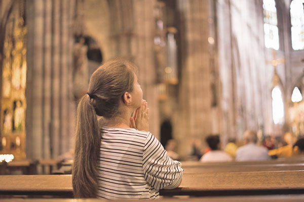 Young Girl Praying In Church