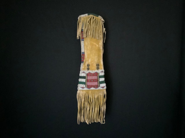 PRODUCT PROFILE :
Product No. : #11217
Description :  Cheyenne Child’s
 Bar Design Pipebag 
PRODUCT NARRATIVE:
• Native tanned hide w/ painted
yellow ochre.
• Size: 14" Length
• Circa: 1880's


