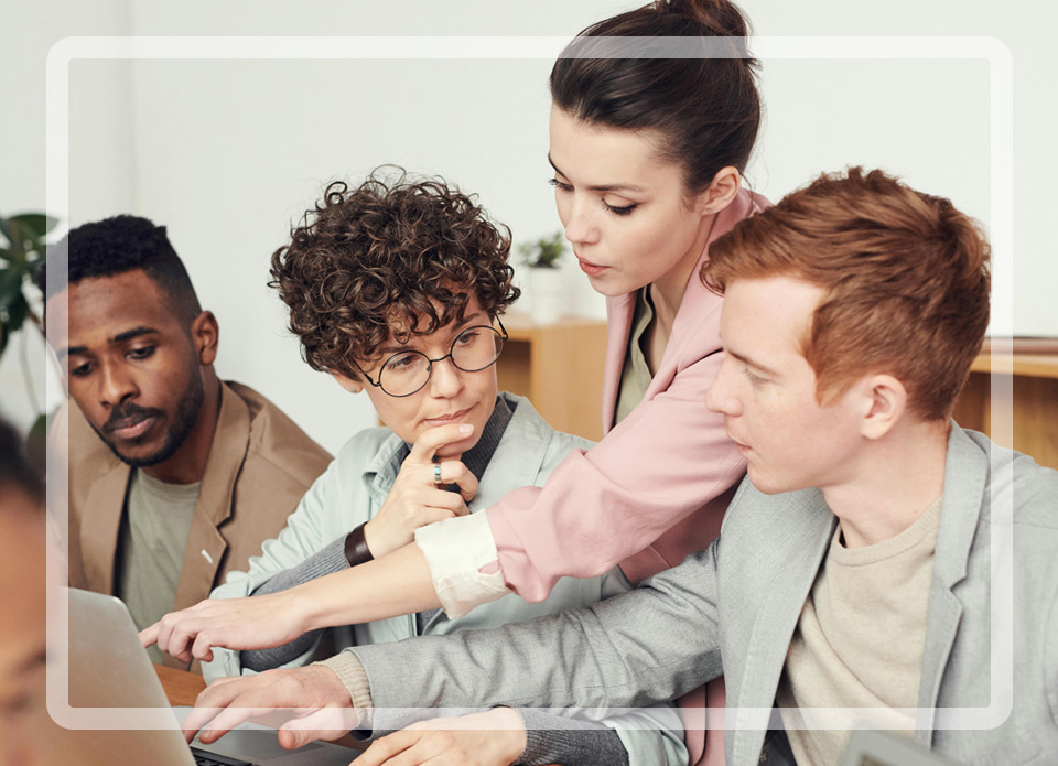 Group of people working in a meeting setting