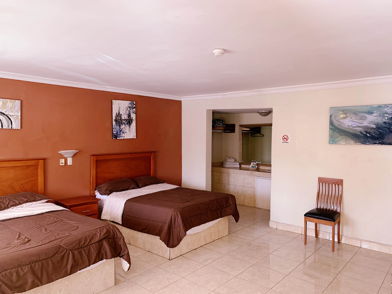 Hotel room with a double bed and a sofa