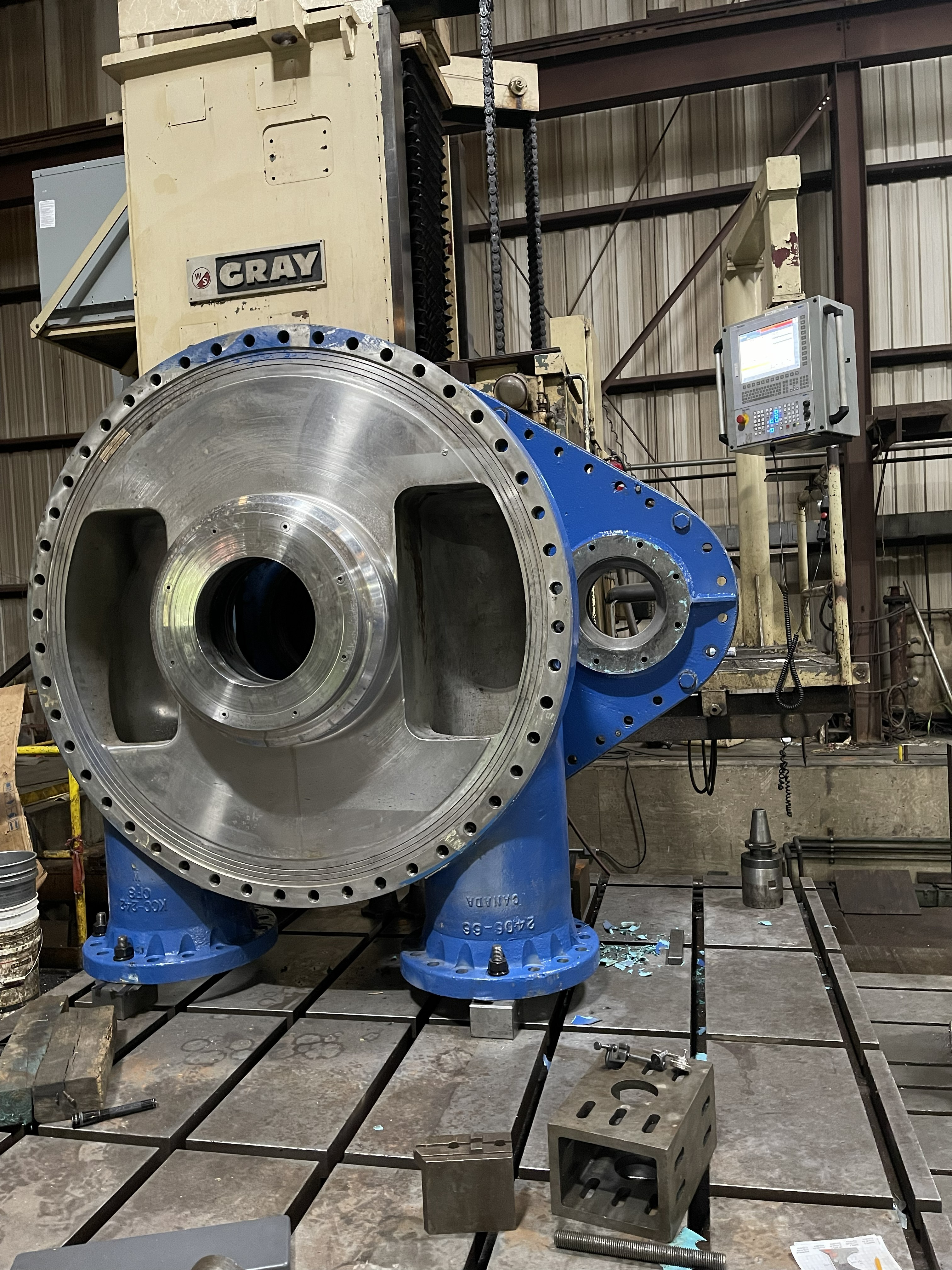 Modern warehouse interior with rows of metal cabinets and computer workstations, illuminated by overhead lights.