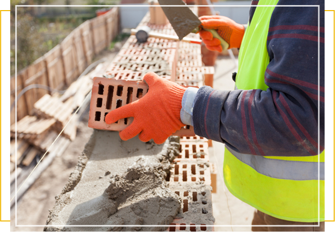 Construction Mason Worker Bricklayer Installing Red Brick With Trowel Putty Knife Outdoors