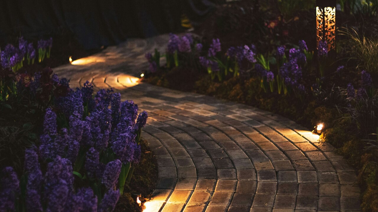 lighted brick pathway with flowers