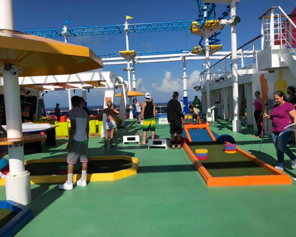 Cruise ship deck with a mini-golf course in use.