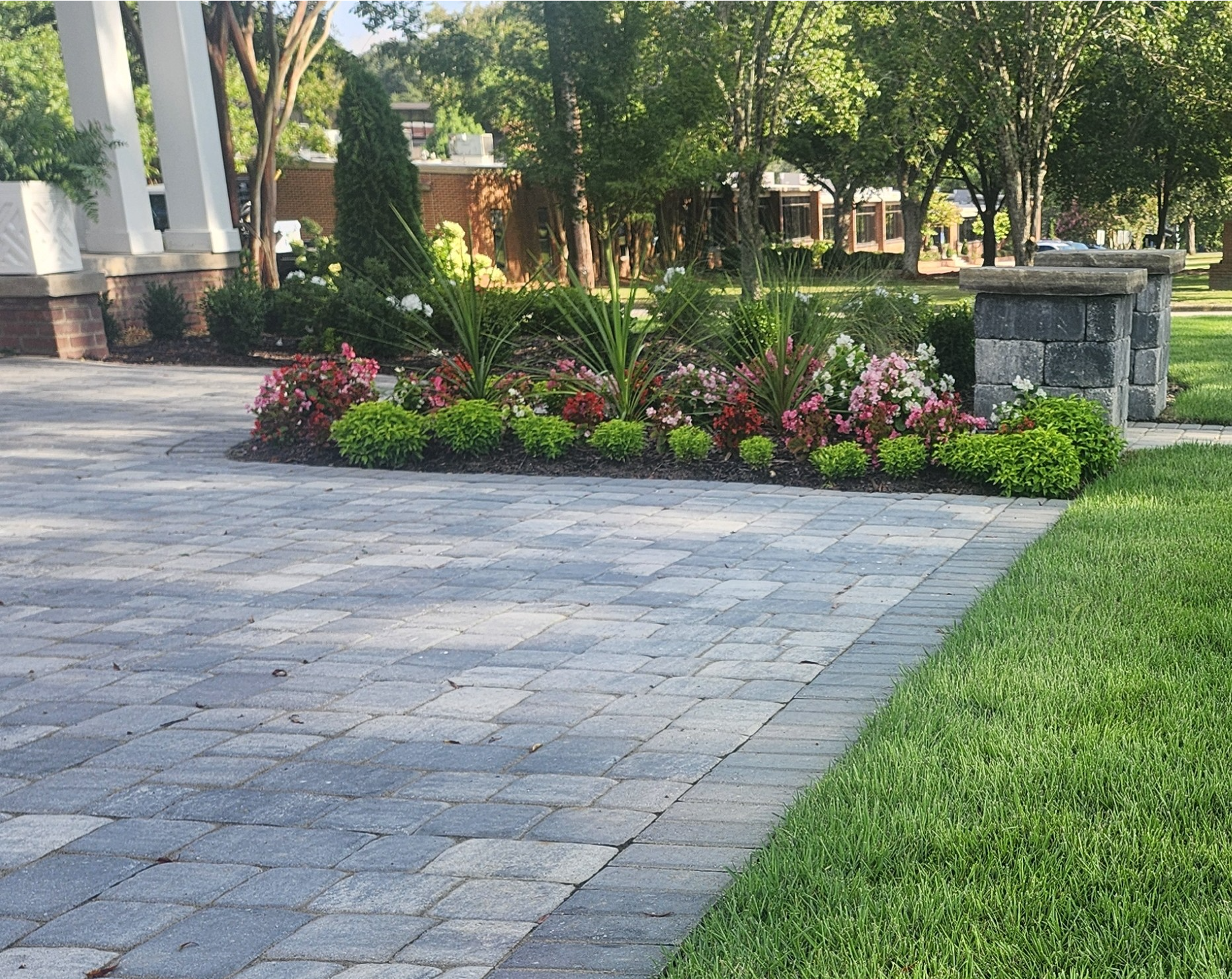 Serene garden path with lush greenery, purple flowers, and soft sunlight filtering through trees.