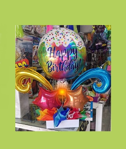 Happy child with glasses holding books and an apple on top
