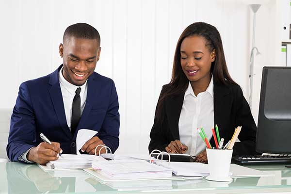 Businesspeople Working On Business Document