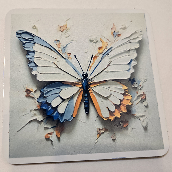 Square metal coaster with a painted butterfly design
