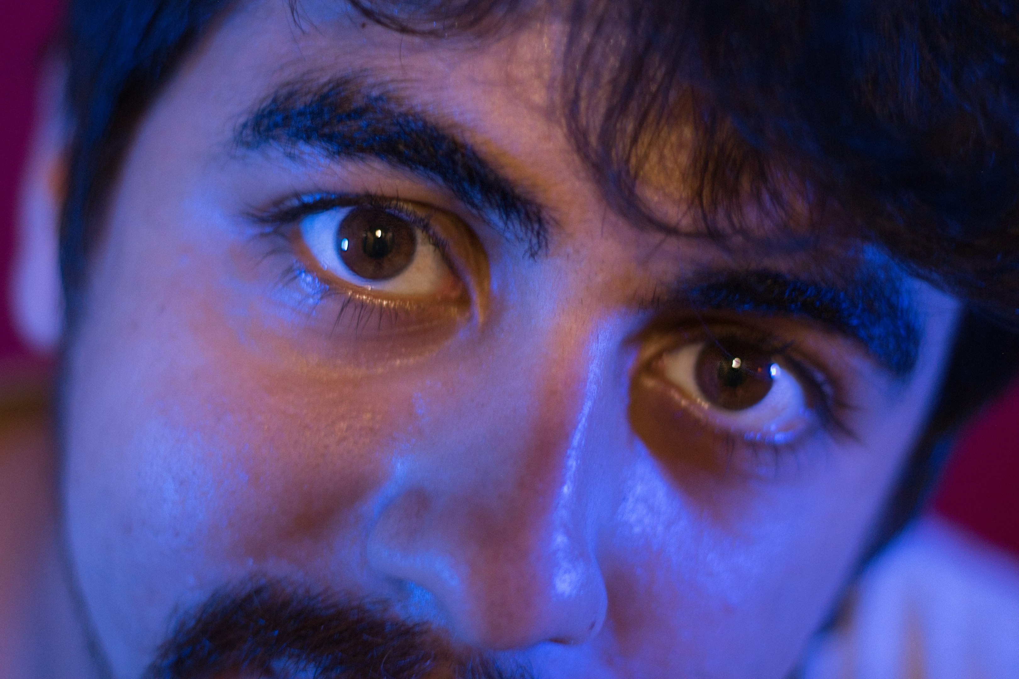 Intense eyes stare directly at the viewer.