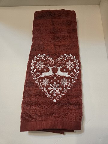 Red hand towel featuring a white heart with reindeer design