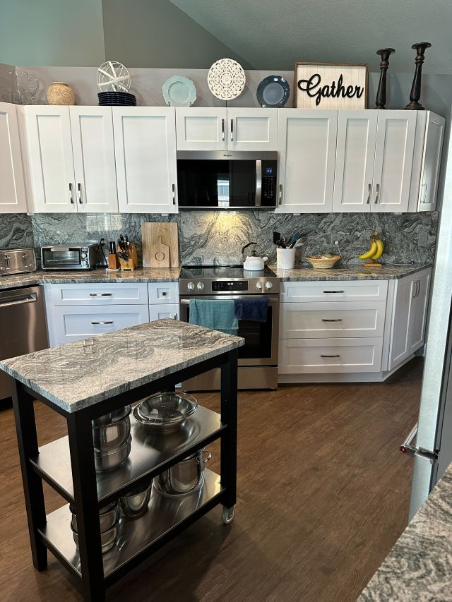 A versatile, granite-topped movable storage piece adds both practicality and refined style to this space.