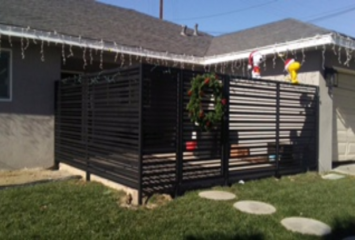 Wrought iron fence around a back patio.