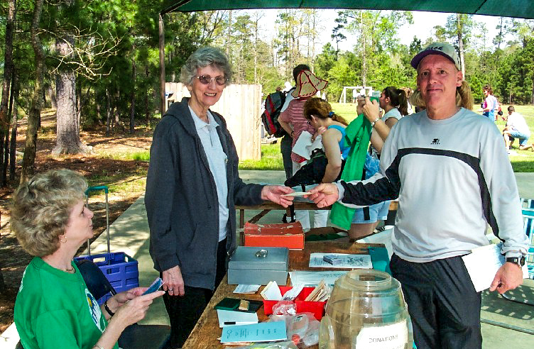 Group of people running in an outdoor urban marathon with skyscrapers in the background, sunny day. Group of people running in an outdoor urban marathon with skyscrapers in the background, sunny day.