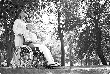 Senior in Wheelchair and Nurse