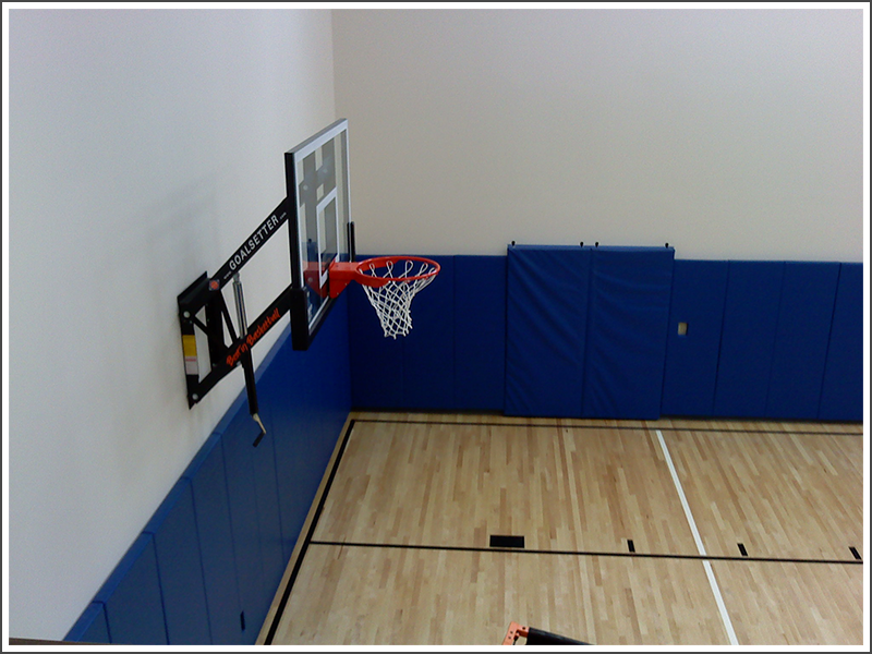Blue padded gym wall||||