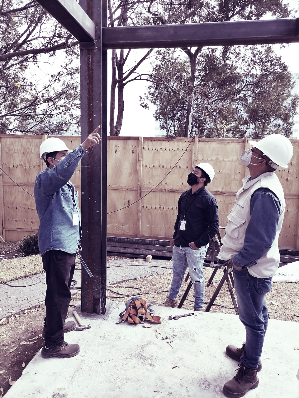 Two businessmen talking and looking at laptop screen