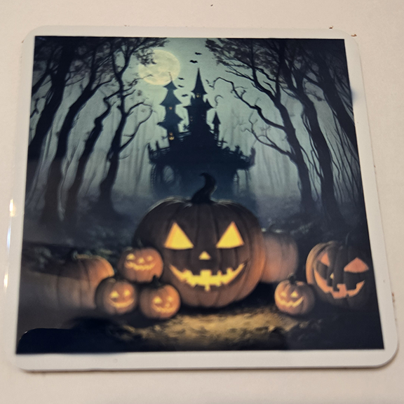 Square metal coaster with a pumpkins at night design