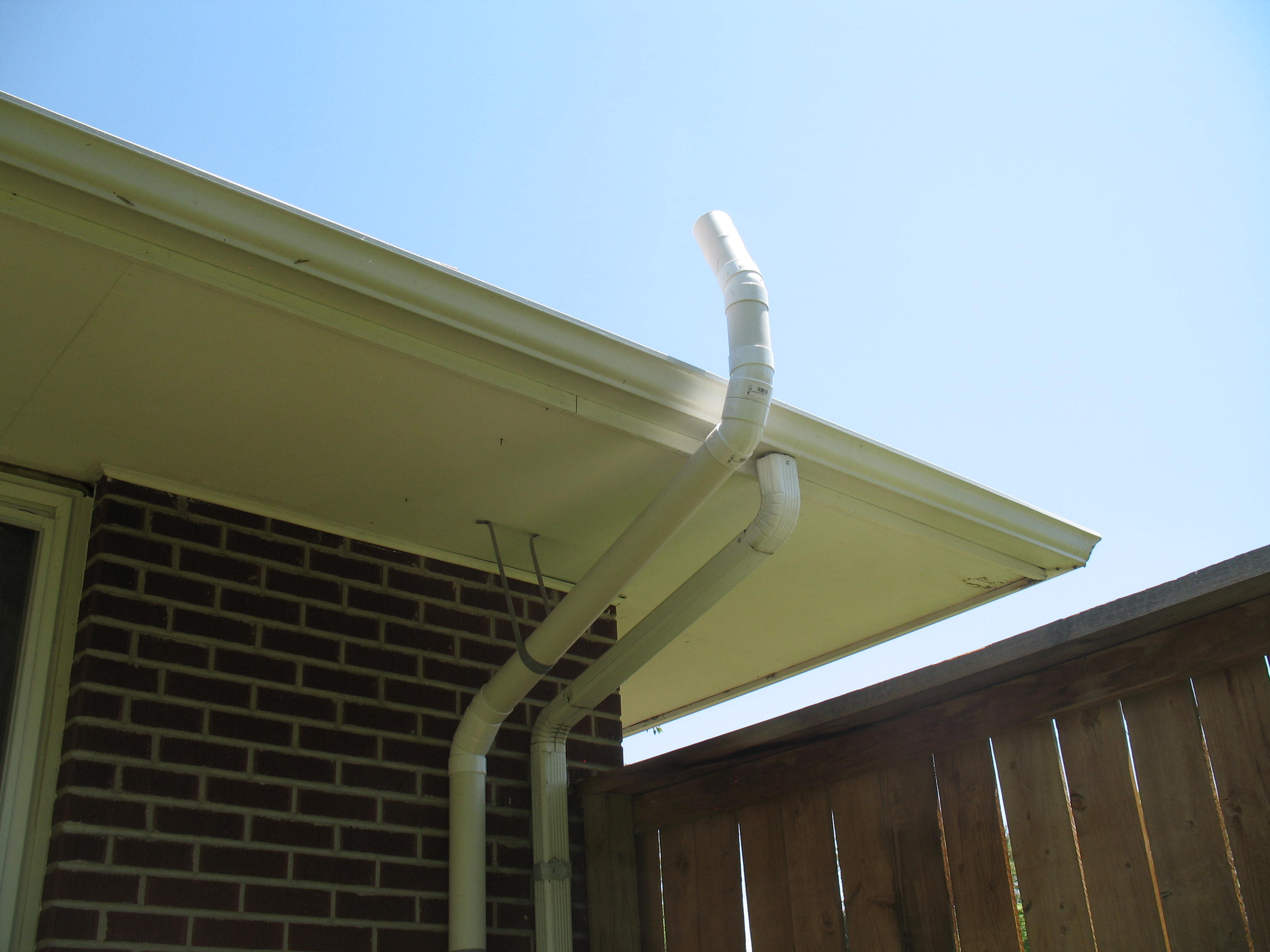 Outdoor system piped parallel to downspout