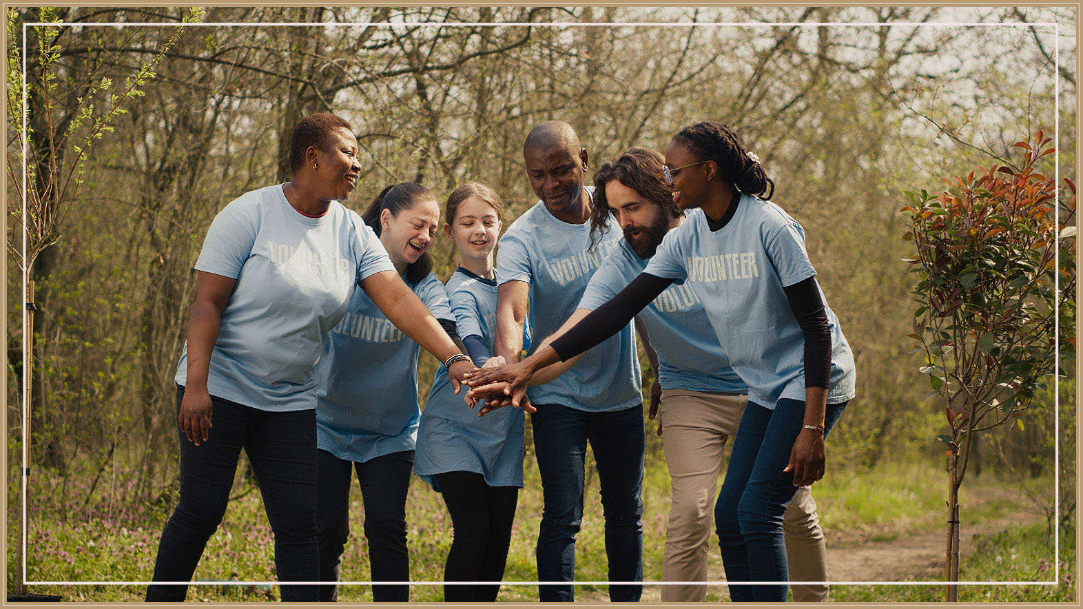 Group of volunteers with their hands stacked together between them.