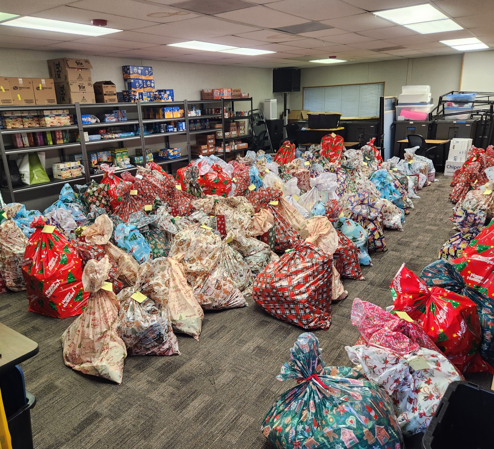 Volunteers distributing food and clothing donations at a community charity center