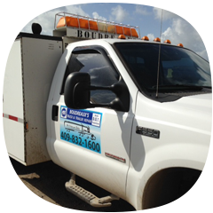 White utility truck with company logo and contact number on side door, parked outdoors under blue sky.