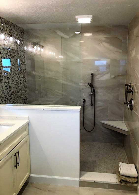 Flawless walk-in shower featuring a 
spacious seat with elegant tile work.