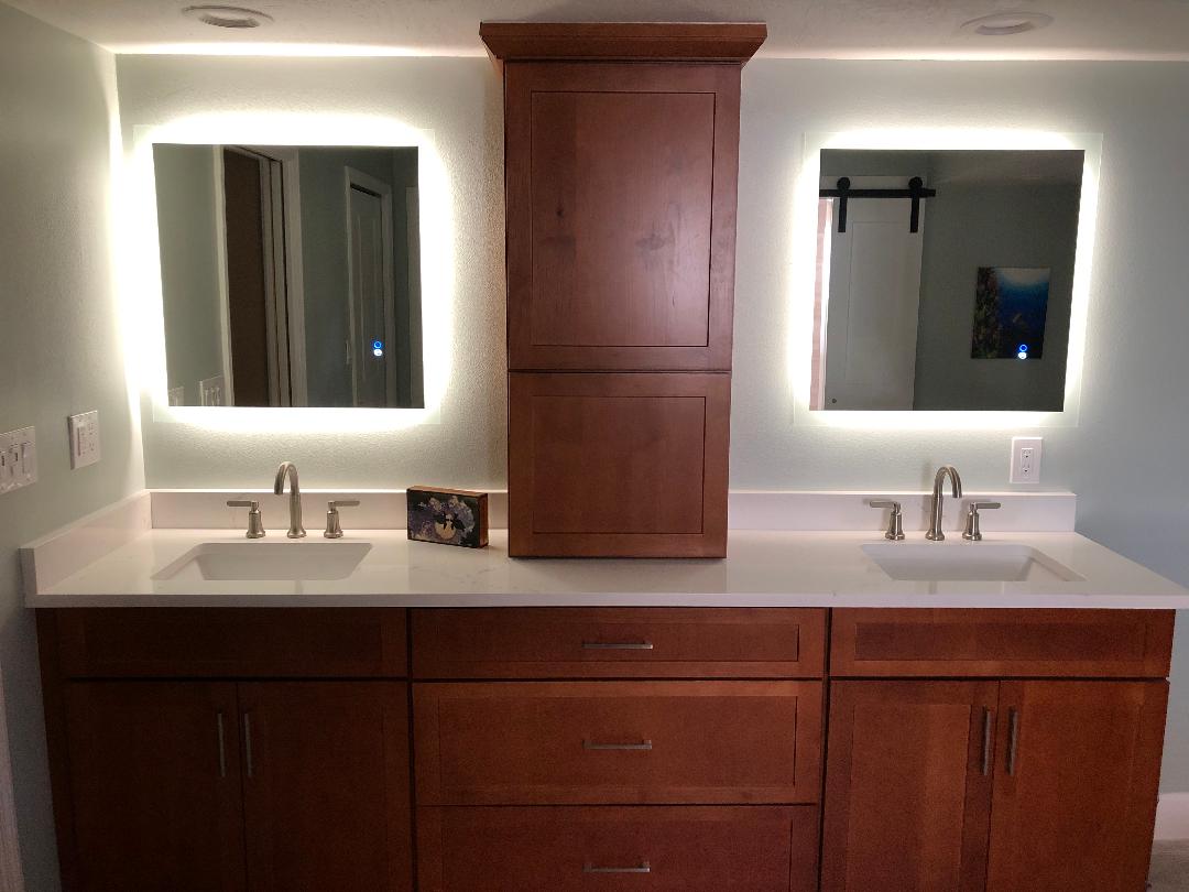 Featuring back lit mirrors with matching tower and dual sinks.
