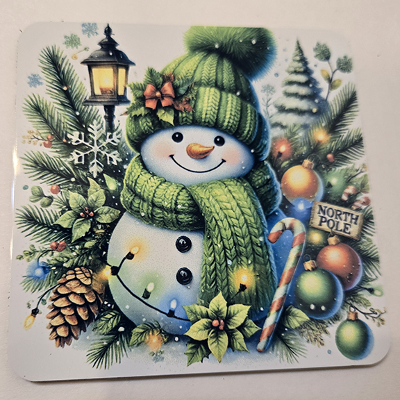 Square metal coaster with a snowman design