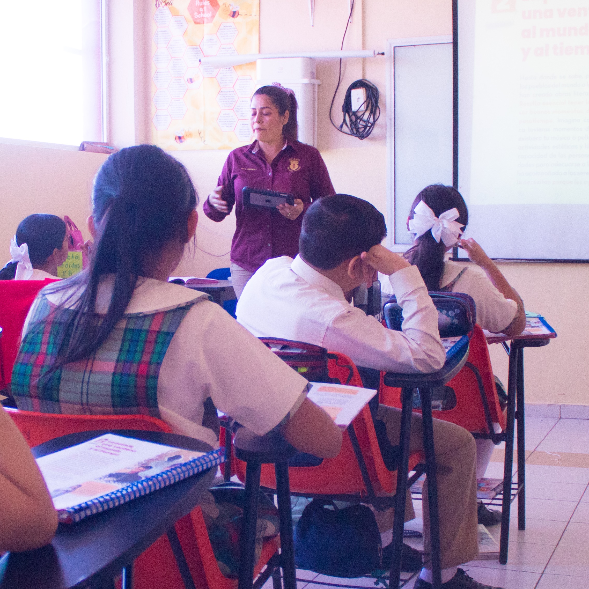 Smiling teacher holding a notebook