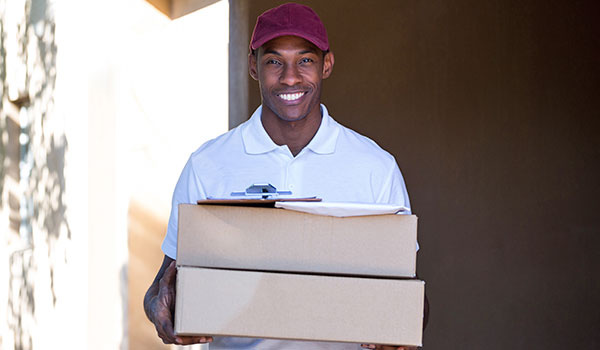 Happy Delivery Man Holding a Parcel
