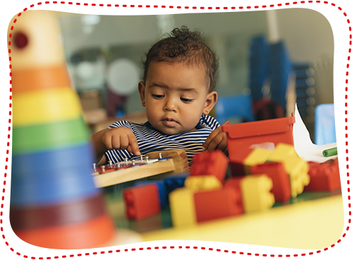 Happy Baby Playing with Toy Blocks