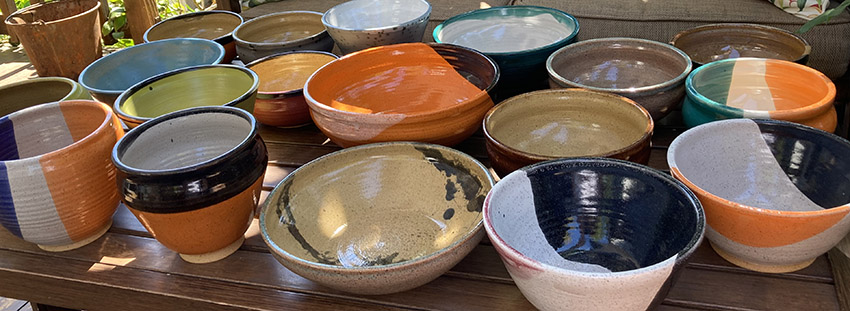 person making clay pot on the floor